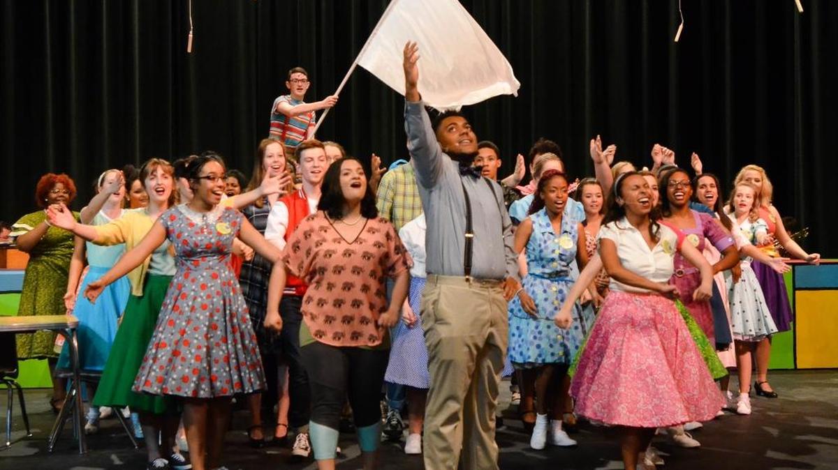 Mr. MacAfee (Kageman Mason, front center) leads Hymn For a Sunday Evening. Bryan Station High School Theatre presents Bye, Bye Birdie, April 21 to 23.