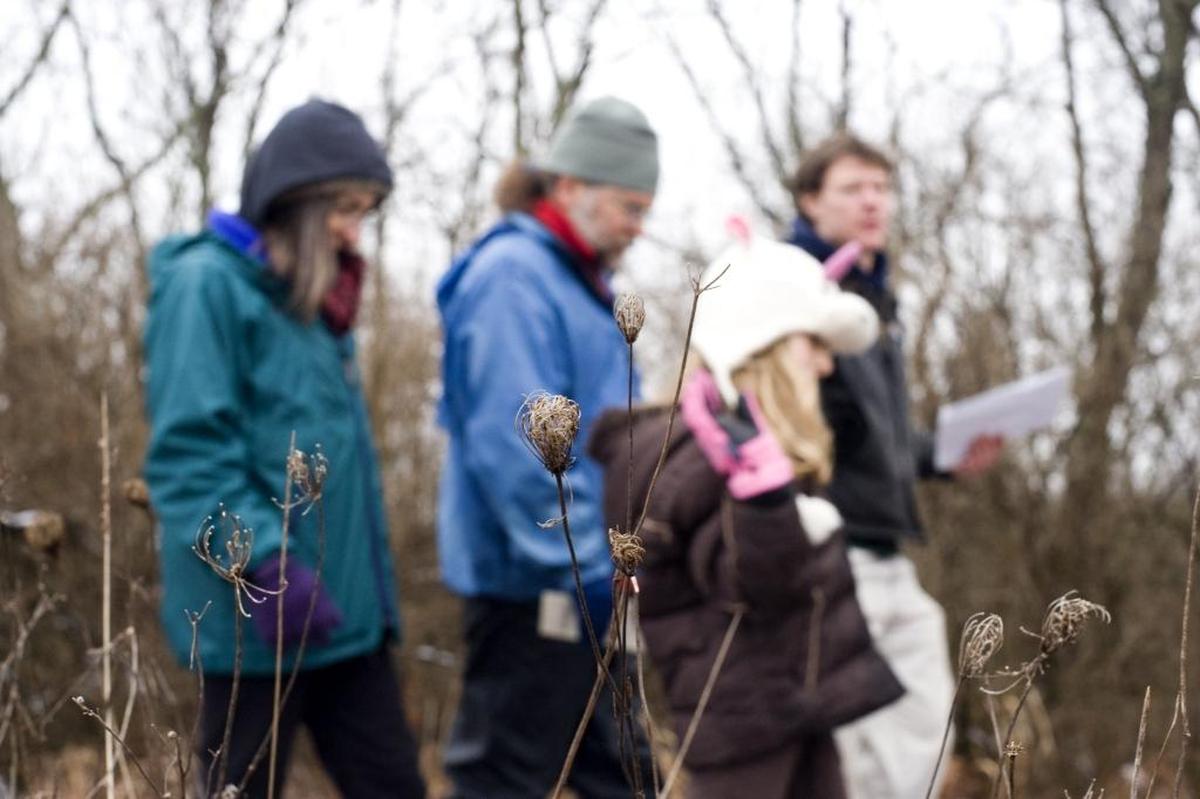 From left, Holly and Jonathan Gilpin of Lexington, their daughter, Clara, 9, and Chase Clark, programming assistant at Raven Run Nature Sanctuary, walked back to the visitor center after a small hike to the Prather family house on Jan. 1, 2013.