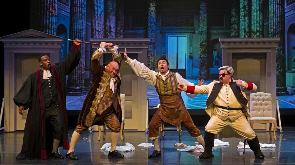Basilo (Bongani Ndhlalane), Bartolo (Kevin Glavin), Figaro (Taeeun Moon) and Almaviva (Taylor Comstock) get in a row near the end of Act I of the University of Kentucky Opera Theatre’s production of “The Barber of Seville,” through Feb. 26 at the Singletary Center for the Arts.