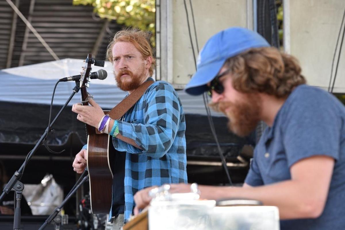 Tyler Childers and pedal steel player James Bartlett play at the MoonTower Music Festival.