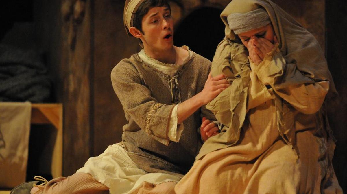 Joshua Steinbach, as Amahl, tries to comfort his mother (Whitney Myers), who is in despair about their poverty.
