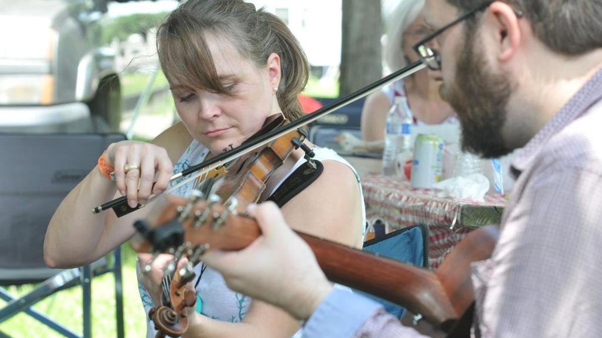 Natalie Hall of Orlando, Fla., plays in a mid-afternoon jam session with some family and friends in the camp ground at the Festival of the Bluegrass. The 43rd annual Festival of the Bluegrass is June 9-12 at the Kentucky Horse Park, 4089 Iron Works Parkway, in Lexington, Ky. This photo was taken June 10.