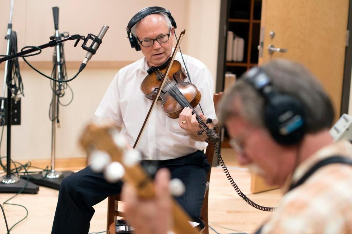 Raymond W. McLain, left, and Al White recorded a track at the Kentucky Center for Traditional Music studio in Morehead. The McLain Family Band is recording an album to celebrate its 50th anniversary.