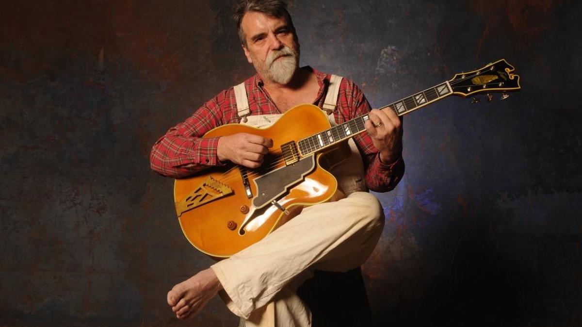 Darrell Scott’s most recent album is full of songs recorded 15 years ago. His next album, due out this summer, was recorded in 2009.