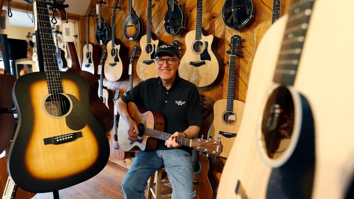 Owner Bob Willcutt played a guitar in his store at 406 Rosemont Gardens. Willcutt will celebrate his 50th year in the guitar business on May 12 with a celebration at the store.