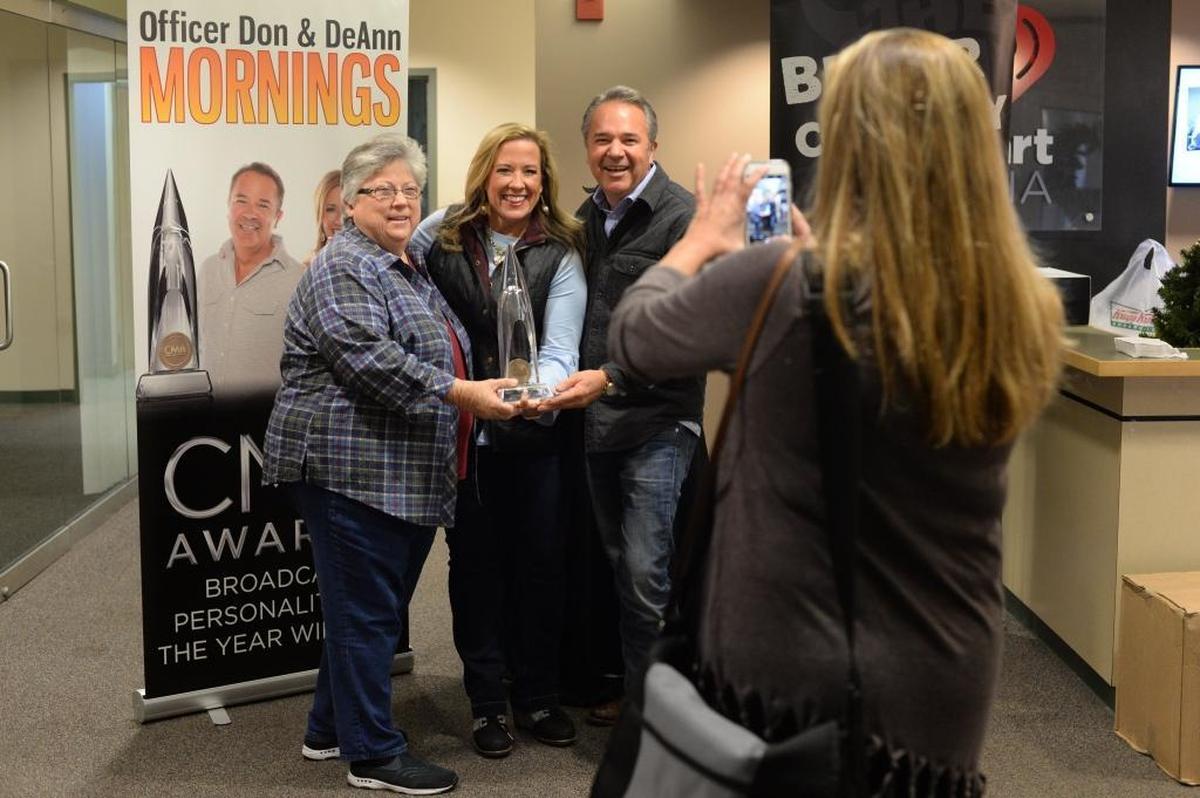 Patty Murphy, left, of Lexington stopped by the iHeart Media offices on Nicholasville Road to congratulate DeAnn Stephens and Don Evans on winning a CMA Award. iHeart Media sales rep Meredith Tyson took their picture.