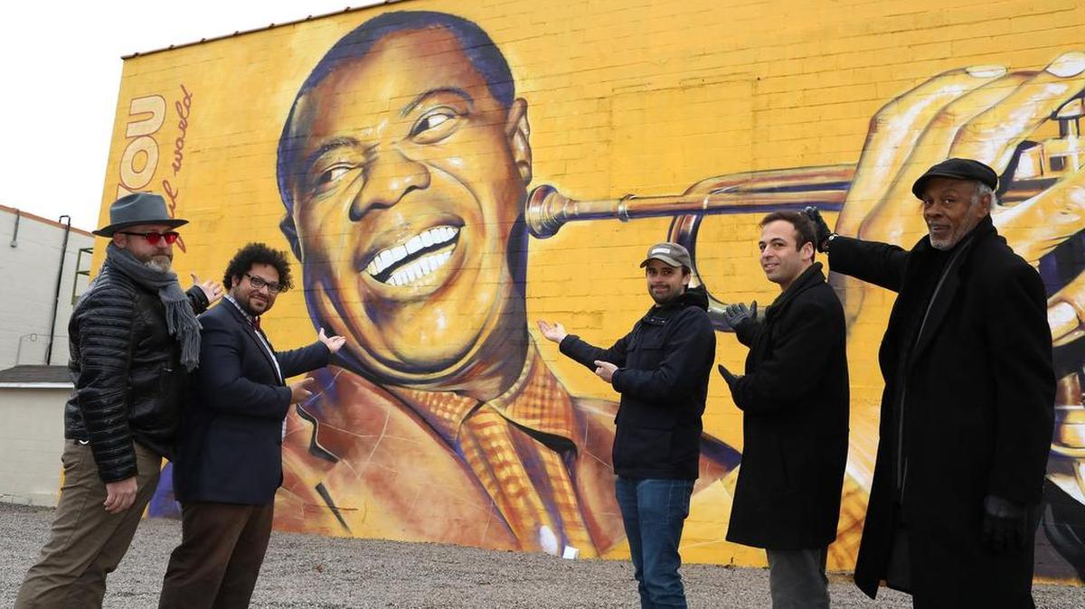 From left, Shawn Gannon, Donald Mason, Richard Young, Eli Uttal-Veroff and Chester Grundy, organizers of a new series of jazz concerts, at the mural of Louis Armstrong outside Lighthouse Ministries.