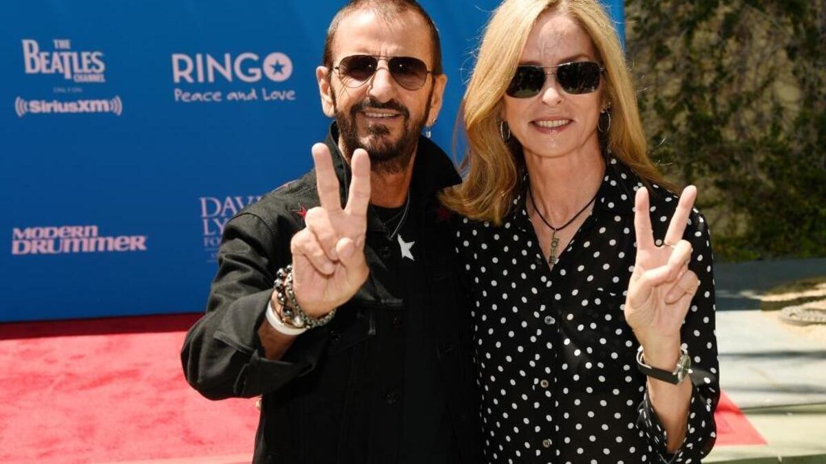 Ringo Starr and his wife Barbara Bach give the peace sign to photographers during a 77th birthday celebration for Starr at Capitol Records on Friday, July 7, 2017, in Los Angeles. (Photo by Chris Pizzello/Invision/AP)