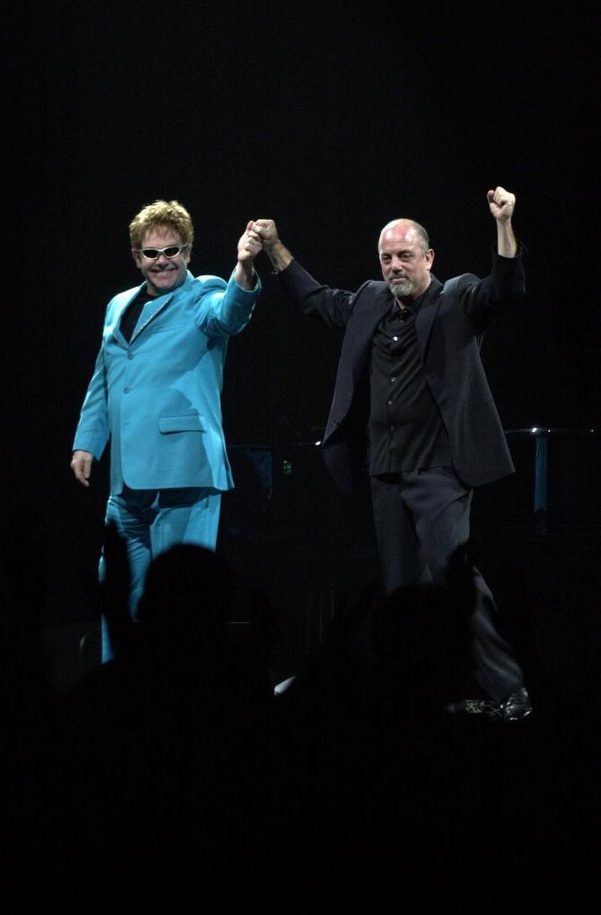 Elton John, left, and Billy Joel greet the Rupp Arena crowd before the show on March 12, 2003. Tickets for the show were $186.25.