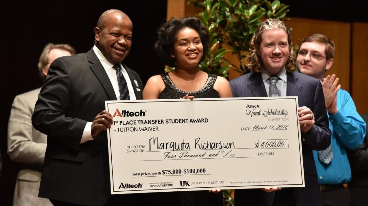 Everett McCorvey (left) and Mark Lyons (right) present Marquita Richardson (center) with the 1st place transfer student award in the Alltech Opera competition at UK.