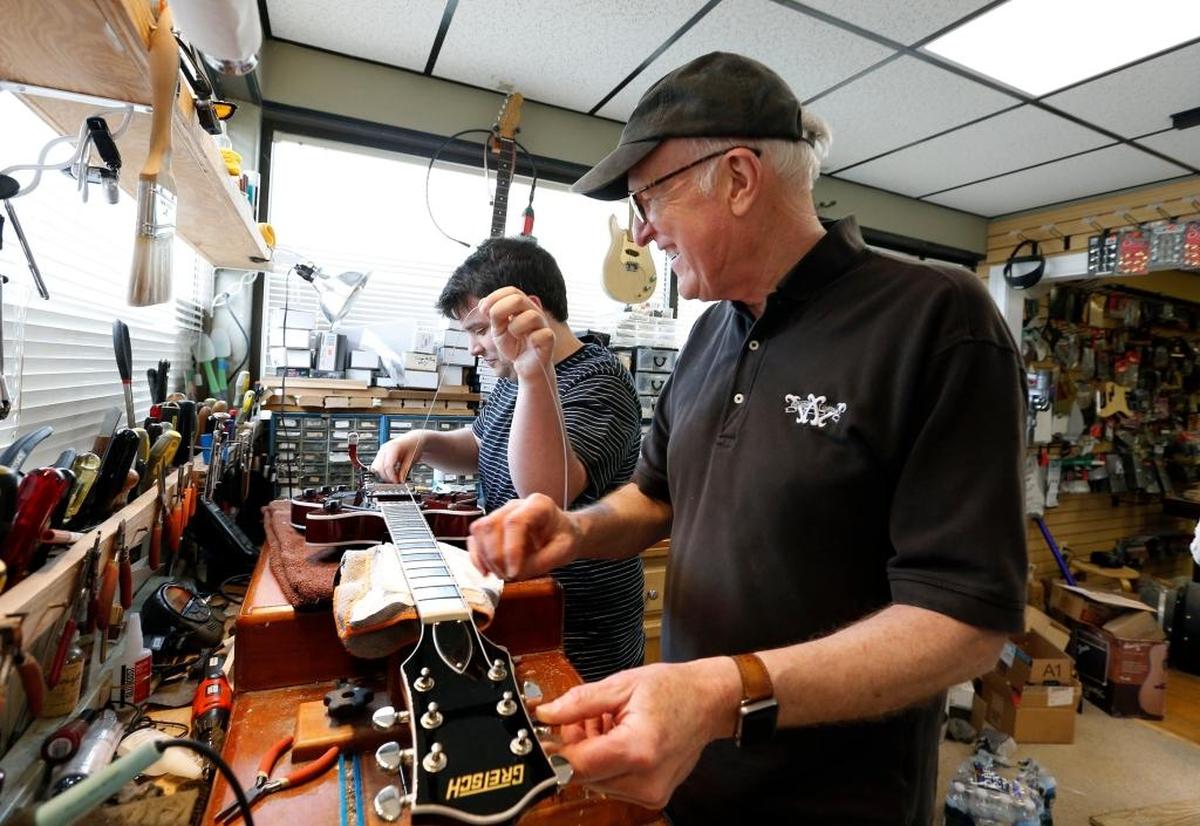 Owner Bob Willcutt, right, helped Ben Jacobs work on a guitar in the service area at Willcutt Guitars. The store will celebrate its 50th anniversary on May 12 with a celebration at the store at 406 Rosemont Garden.