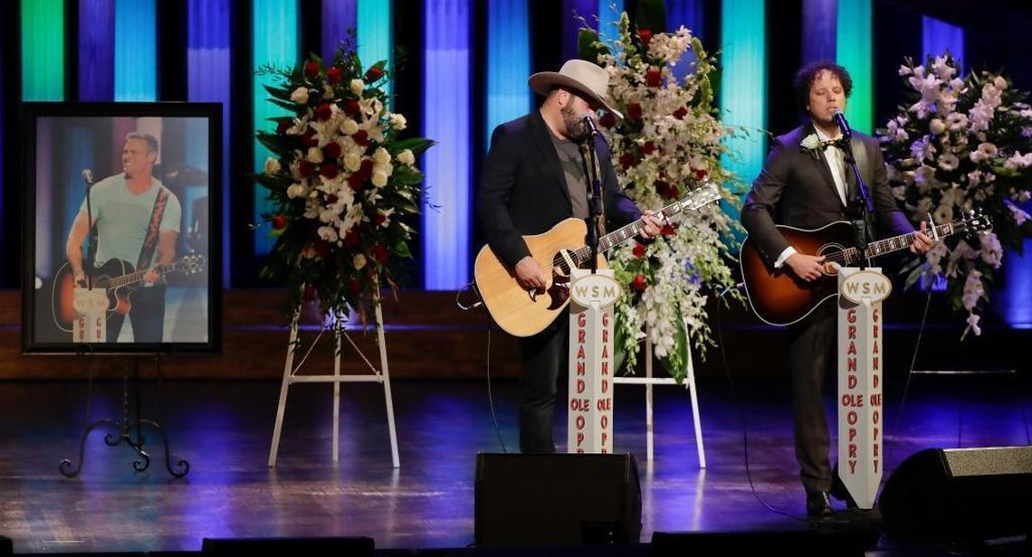 David Tolliver, left, and Chad Warrix, of the duo Halfway 2 Hazard, perform during a memorial service for country music singer Troy Gentry at the Grand Ole Opry House Thursday, Sept. 14, 2017, in Nashville, Tenn. Gentry, who made up the duo Montgomery Gentry with Eddie Montgomery, died Sept. 8 in a helicopter crash.