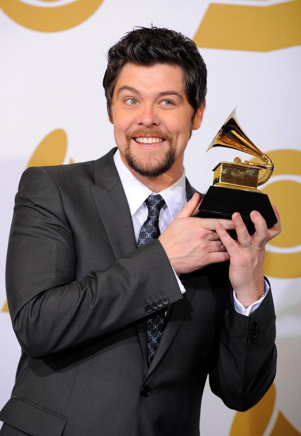 Jason Crabb holds the southern, country or bluegrass gospel award for his solo debut “Jason Crabb” backstage at the 2010 Grammy Awards.