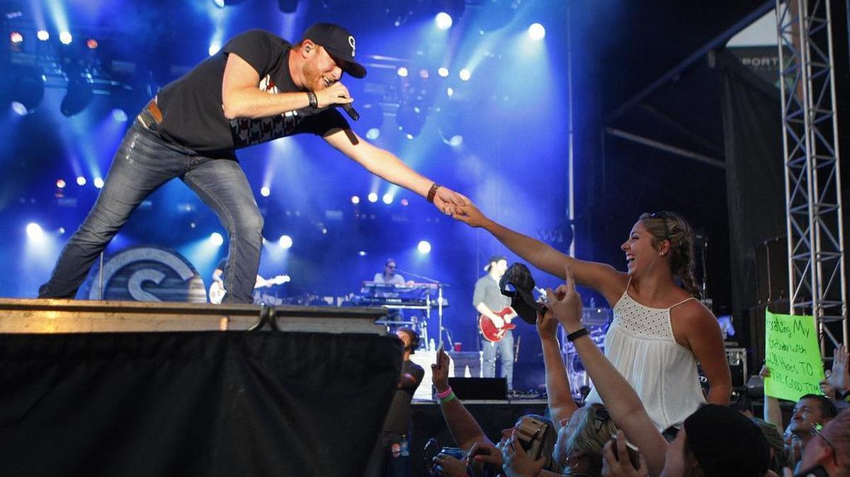 Cole Swindell shook hands with Cali Franklin during Red White and Boom Sunday at Whitaker Bank Ballpark.