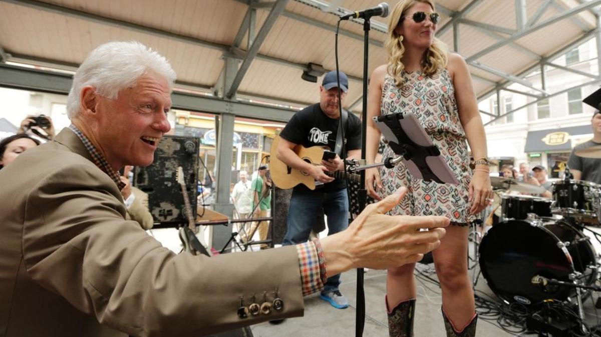Former President Bill Clinton, looked for a hand to get on stage with Lauren Mink band as he campaigned for wife Hillary Clinton at Thursday Night Live at Cheapside Park in Lexington, Ky, on May 12, 2016. Hillary Clinton is the front runner for the Democratic nomination for President. The Kentucky primary is Tuesday, May 17.