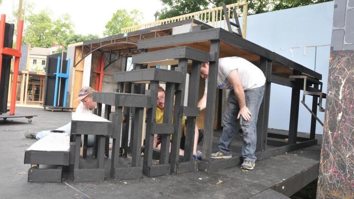 Barbara Clifton, Adam Smyth and John Barton work to paint the stage in Woodland Park on a recent morning. Workers from Lexington Parks and Recreation and SummerFest worked to ready the stage for the theater festival, which opens June 30 and runs through July 24 in Woodland Park in Lexington, Kentucky.