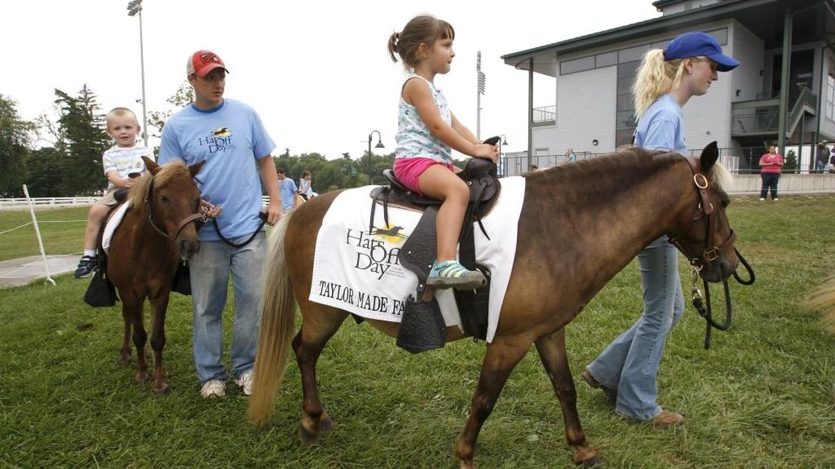 Addison Wilhoite of Owenton rode a pony led by Taylor Davidson at Hats Off Day at the Kentucky Horse Park in 2013. Learn more about other Lexington museum offerings.