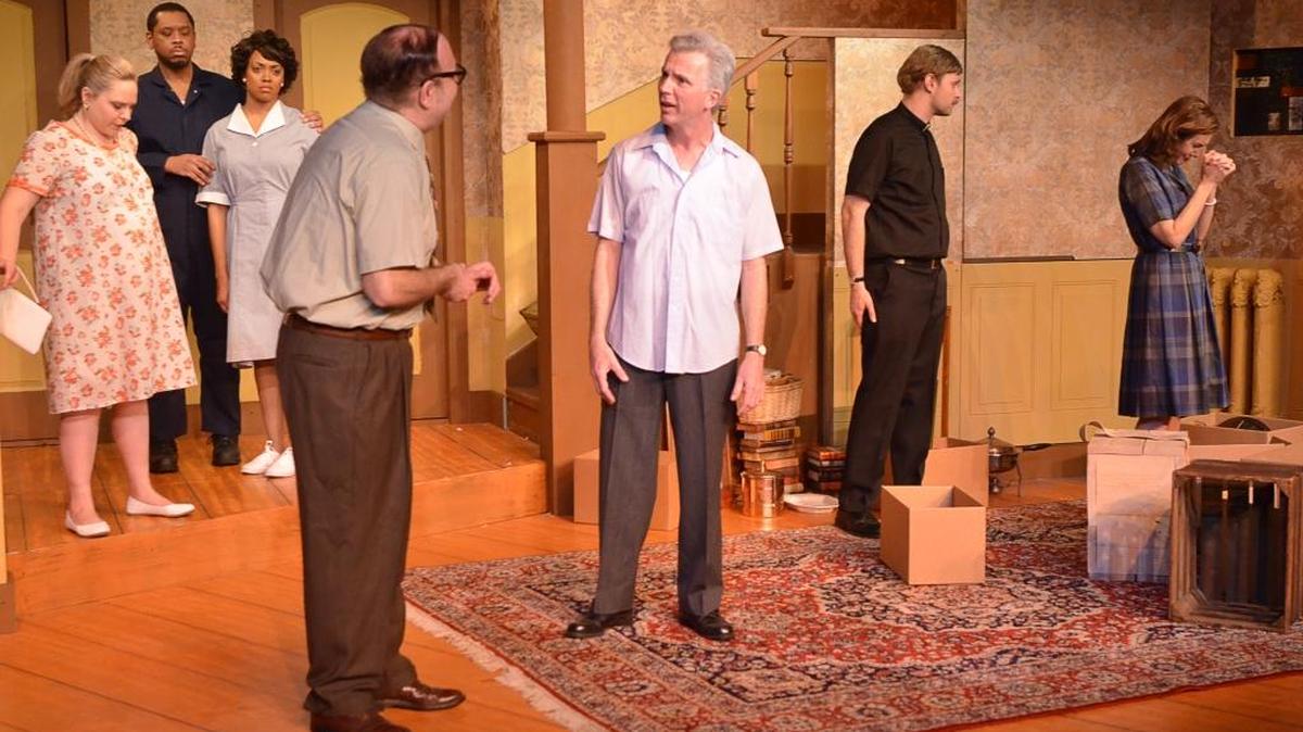 Karl (James Hamblin, foreground left) tries to persuade Russ (Christopher Rose, foreground right) not to sell his home to a black family in the first act, which is set in 1959, of Clybourne Park . Looking on at left are Betsey (Bailey Preston), Albert (Spencer McGuire) and Francine (Meredith Crutcher) while Jim (Burley Thomas), at right, tries to console Bev (Diane Carter).