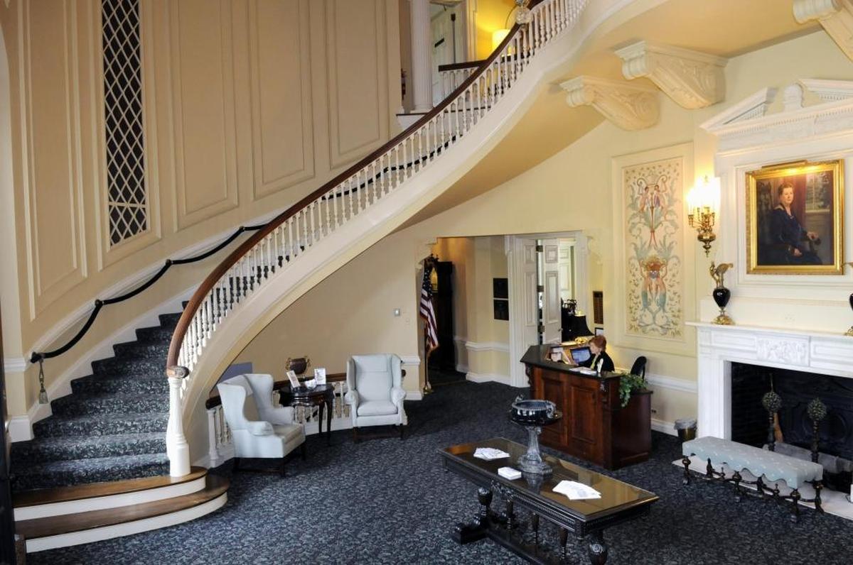 The lobby of The Club at Spindletop Hall features a huge double-curved staircase. In this 2012 photo, a portrait of Pansy Yount, who built Spindletop Hall, hangs above the fireplace.