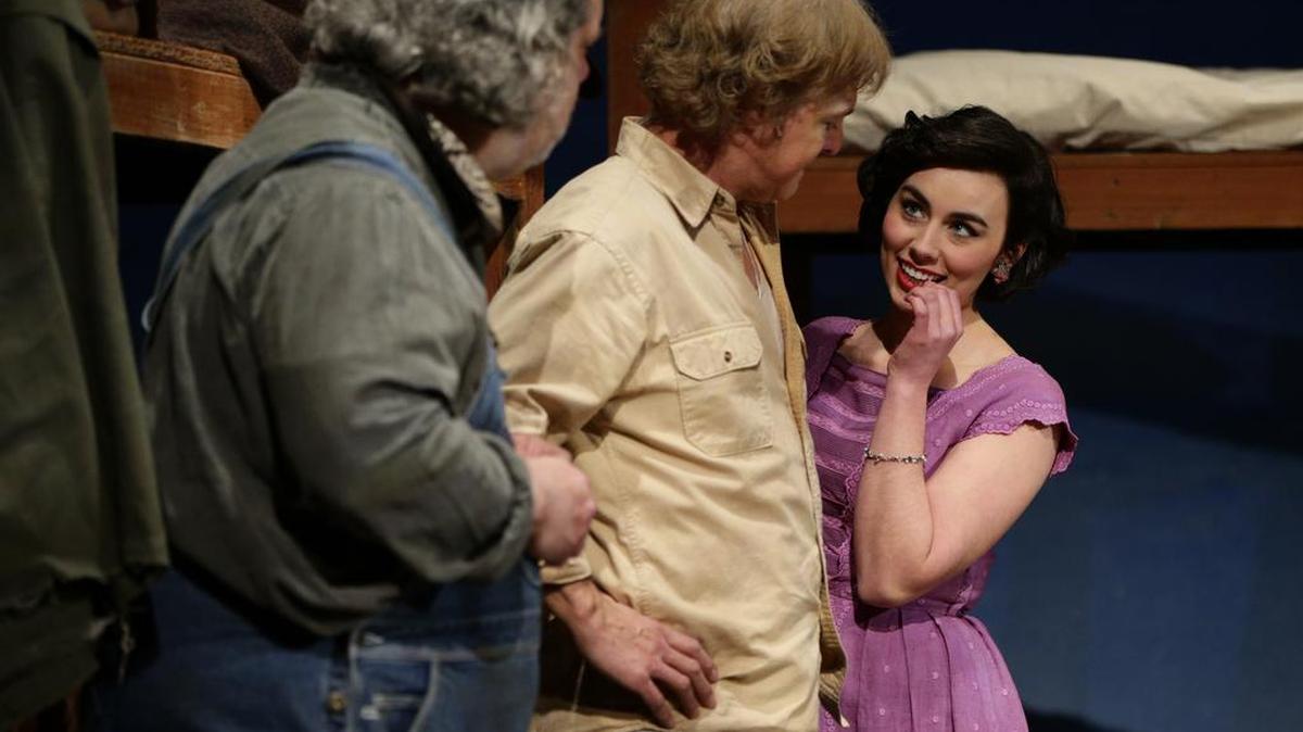 Curley’s wife, portrayed by Courtney Waltermire, flirted with George, played by Kevin Hardesty. At left, Walter Tunis, portraying Lennie.