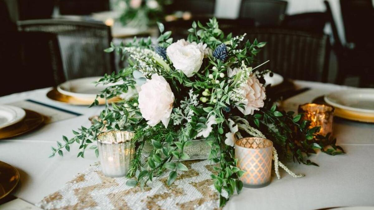 A centerpiece from the 2015 wedding of Ashley Cox. The bouquet is a mix of artificial greenery and paper flowers created by Cox.