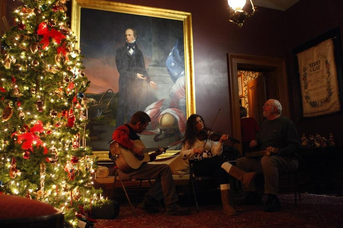 Louie Northern left, his daughter Callie Northern and Mike Grimes entertain guests with Christmas carols during the candlelight tours following Lighting on the Lawn at Ashland, The Henry Clay Estate, in Lexington, Ky., Sunday evening, December 7, 2014. The 2017 tree lighting is Dec. 2, and candlelight tours are Dec. 2 and 9.