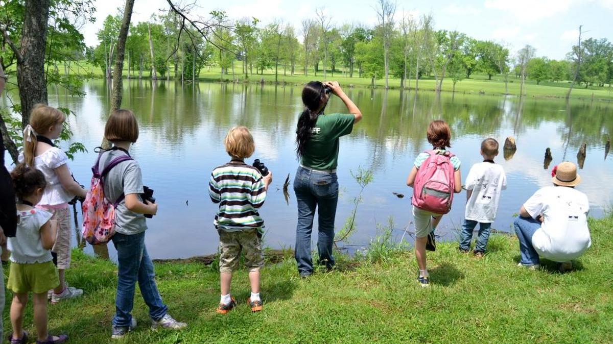 Anna Wiker with Lexington Parks and Recreation, center, leads children on a birding walk as part of the first Bluegrass Birding Festival at Jacobson Park Sunday, May 11, 2014, in Lexington, Ky. The Bluegrass Birding Festival returns this month for the first time since 2019.