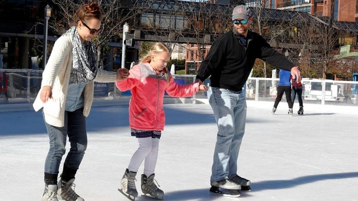Chris and Courtney Treppler skated with their daughter Olivia Gilbert, 9, at the ice rink at Triangle Park in November 2015.