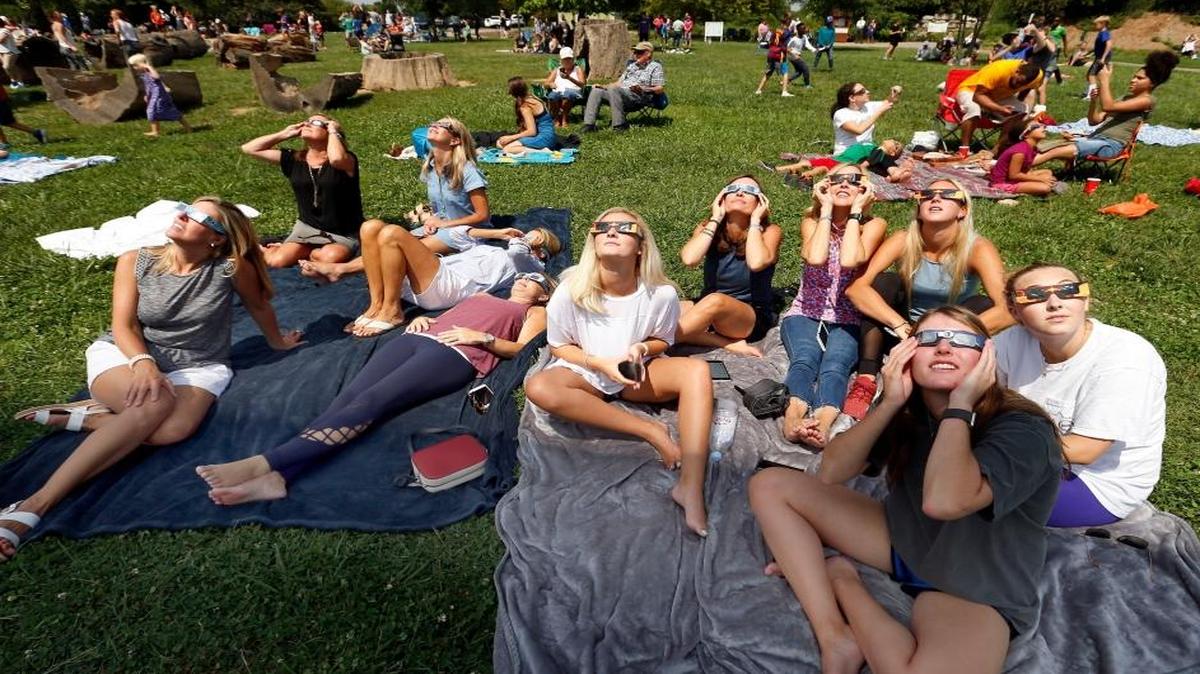 Families and friends watched the partial solar eclipse Aug. 21 at the Arboretum State Botanical Garden on Alumni Drive in Lexington. More than 1,000 people gathered in the Arboretum to watch.