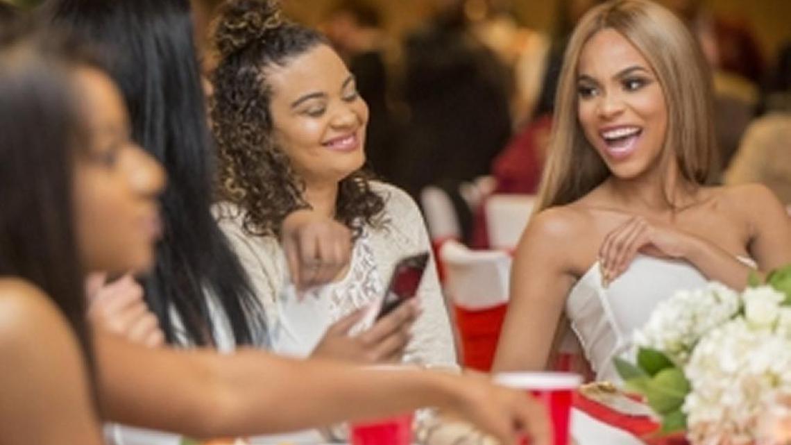 Paducah native Maya Benberry (right) laughed as she watched with friends, including Andrea Davis (second from right), the season finale of E! TV's reality dating show "Catching Kelce." Benberry was one of four finalists featured in the final episode, which ended with her winning the heart of Kansas City Chiefs tight end Travis Kelce. A viewing party for the episode was held Wednesday night at the Walker Hall Events Center in Paducah.