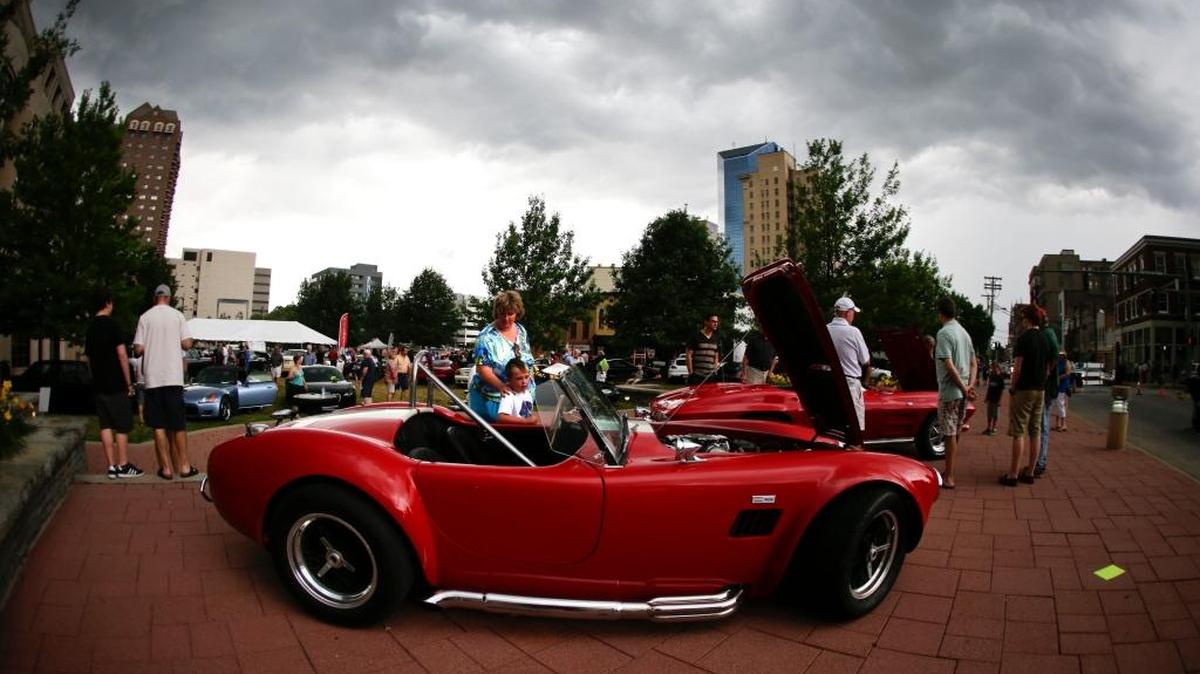 Kathy Kenney and her nephew Brady checked out the cars during the 2014 Keeneland Concours d’Elegance Maserati Mingle at the courthouse plaza in Lexington.