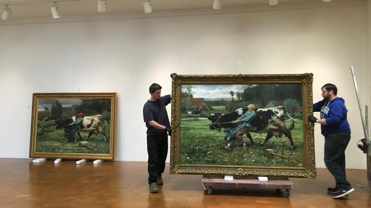 UK preparatorial assistant Nick Guagliardo and UK preparator Alan Rideout move Julien Dupré’s In the Pasture (1883) from the University of Kentucky Art Museum’s collection, next to Dupré’s In Pasture (1882), which has been borrowed from the Mildred Lane Kemper Art Museum at Washington University in St. Louis.