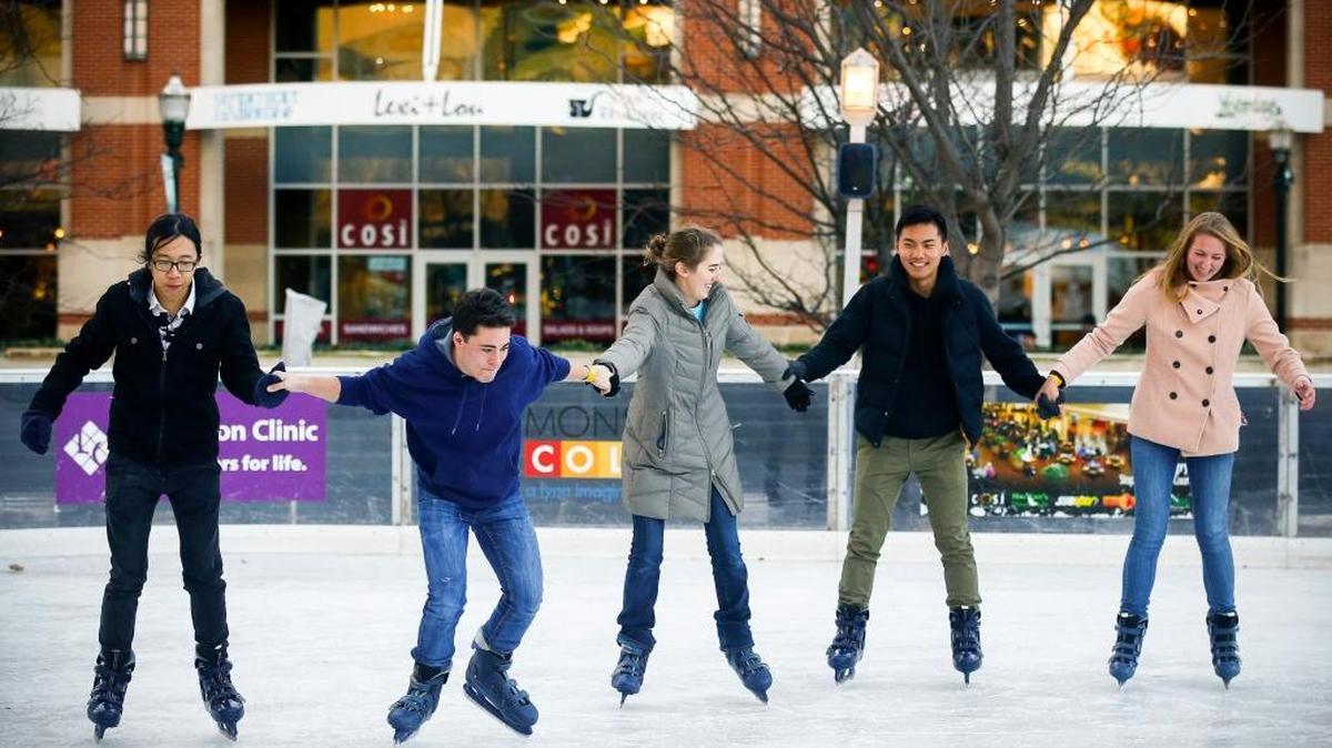 From left, Asbury University students Michaih Li of Guangzhou, China; Dominic D’Ettorre, Tricia Taylor and Josh Hou, all of Wilmore; and Julia Conley of Smithfield., Va., skated Dec. 6 on the Unified Trust Co. ice rink at Triangle Park in downtown Lexington.