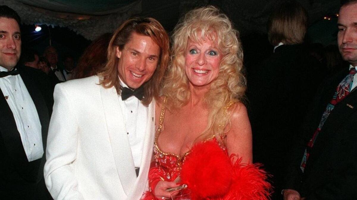 Kato Kaelin and Anita Madden enjoying themselves after entering the Madden Derby Eve party in 1995.