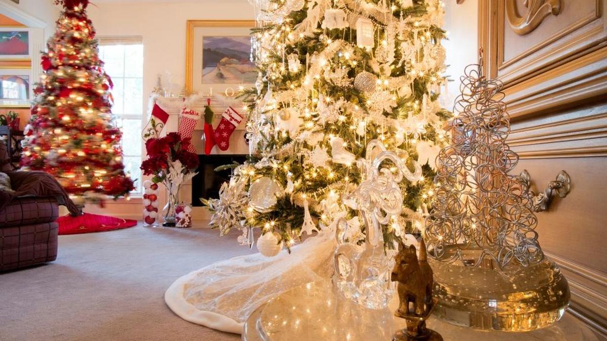 A 10-foot-tall tree in the living room is filled with a mix of crystal and silver ornaments.