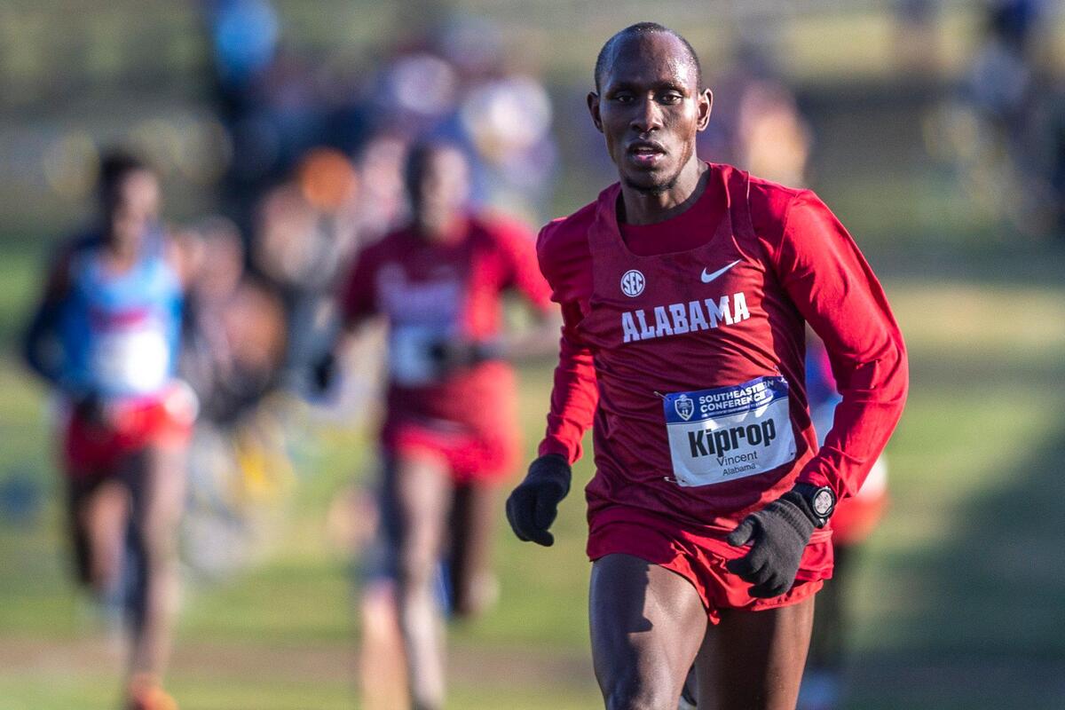 Alabama’s Vincent Kiprop closed in on the finish line on his way to victory in the 8,000-meter men’s race.