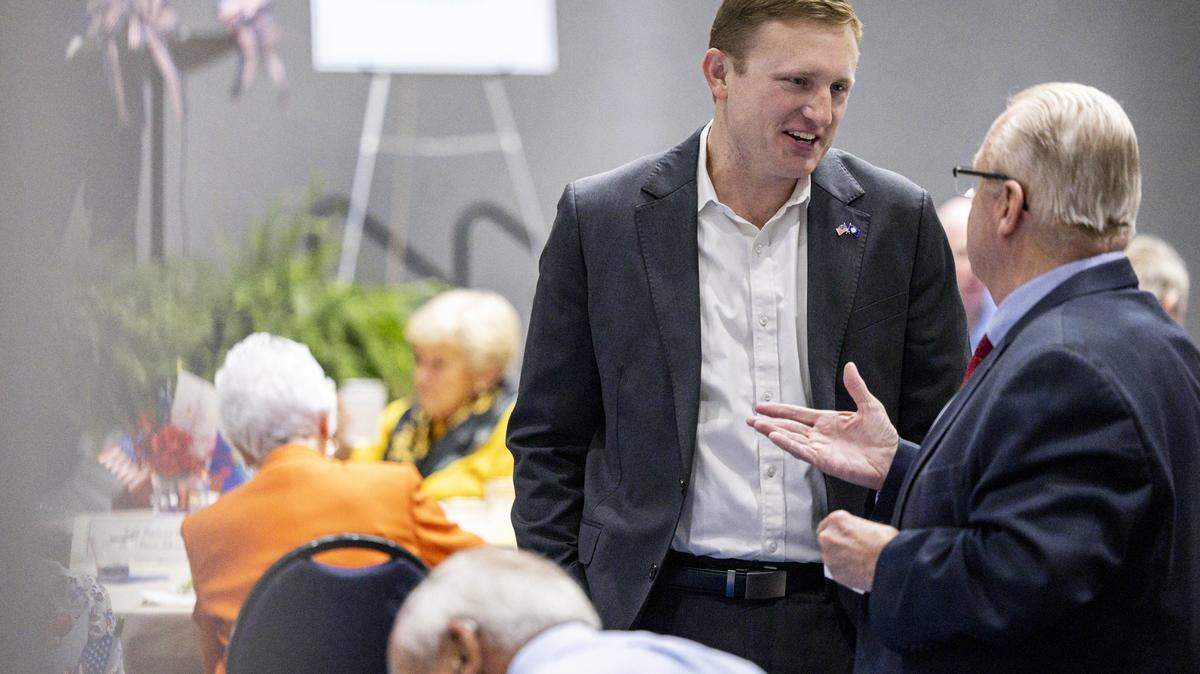 Zach Dembo, a candidate for the sixth district, center, speaks with attendees during the annual Wendell H. Ford Dinner on Tuesday, Sept. 30, 2025, at Clay Community Center in Mt. Sterling, Ky.