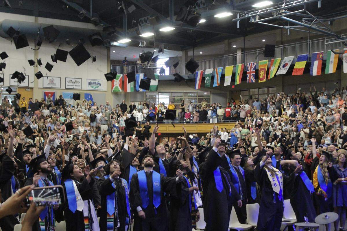 Over 200 Berea College graduates toss their caps in the air at their commencement ceremony on Sunday, May 10, 2026, at Berea College in Berea, Kentucky.