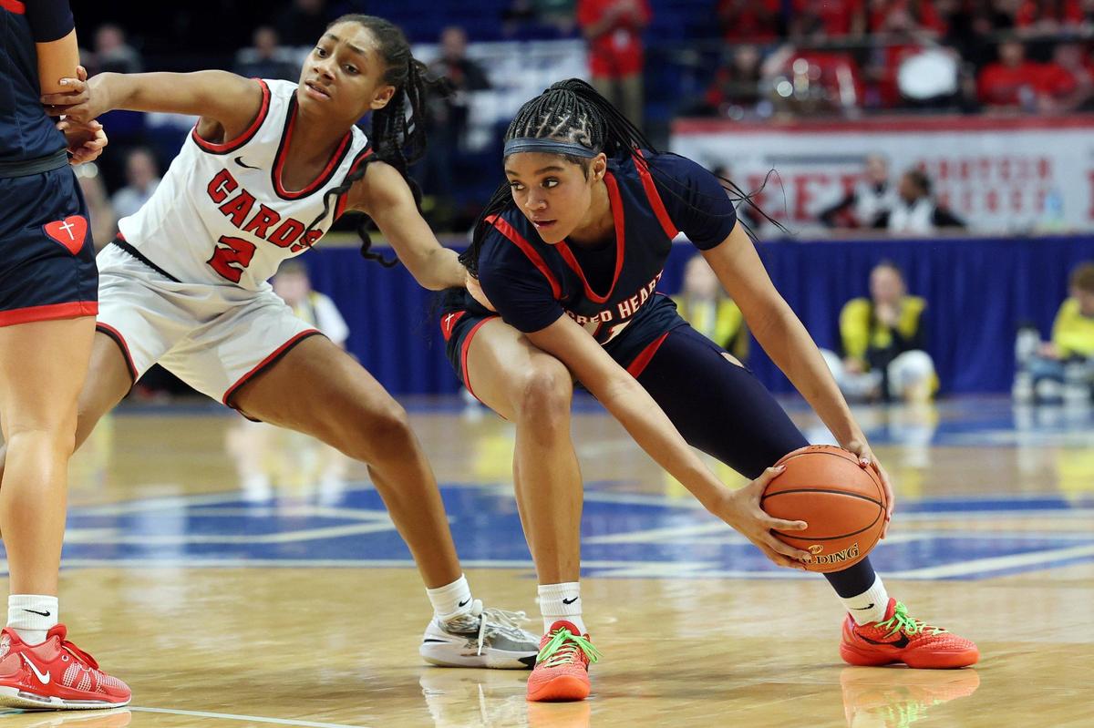 George Rogers Clark’s Teigh Yeast (2) pressures Sacred Heart’s ZaKiyah Johnson (11) during Thursday night’s game. Johnson finished with 18 points.