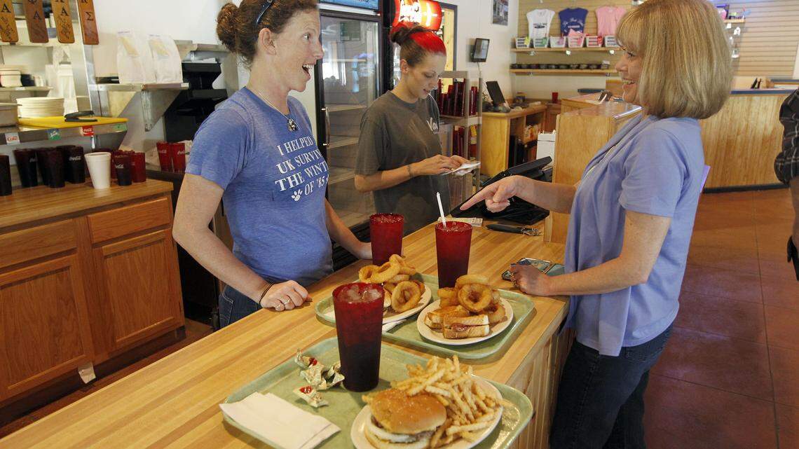 Taylor Hollingsworth served customer Donna Graves at Tolly-Ho's new home on South Broadway. Brittany Norton totaled up the bill.   