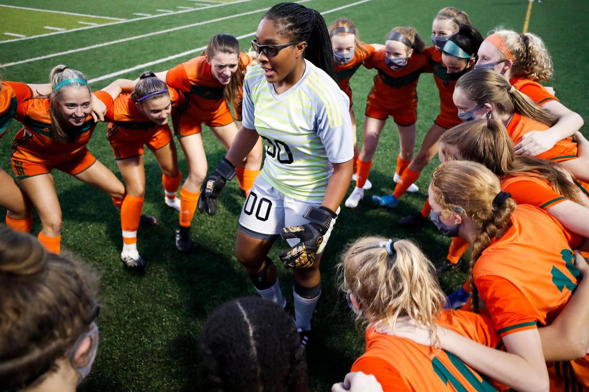 Frederick Douglass senior keeper Maliya Crump (00) rallied with teammates before their game against Henry Clay at Frederick Douglass High School on Sept. 9, 2020.