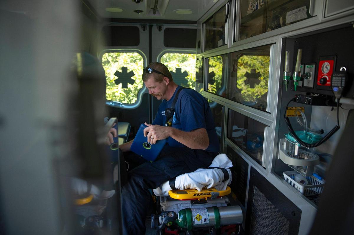 Doug Byers, a Lee County paramedic, looks at an electrocardiogram reading after responding to a call in Lee County, Ky., on Tuesday, Sept. 7, 2021.