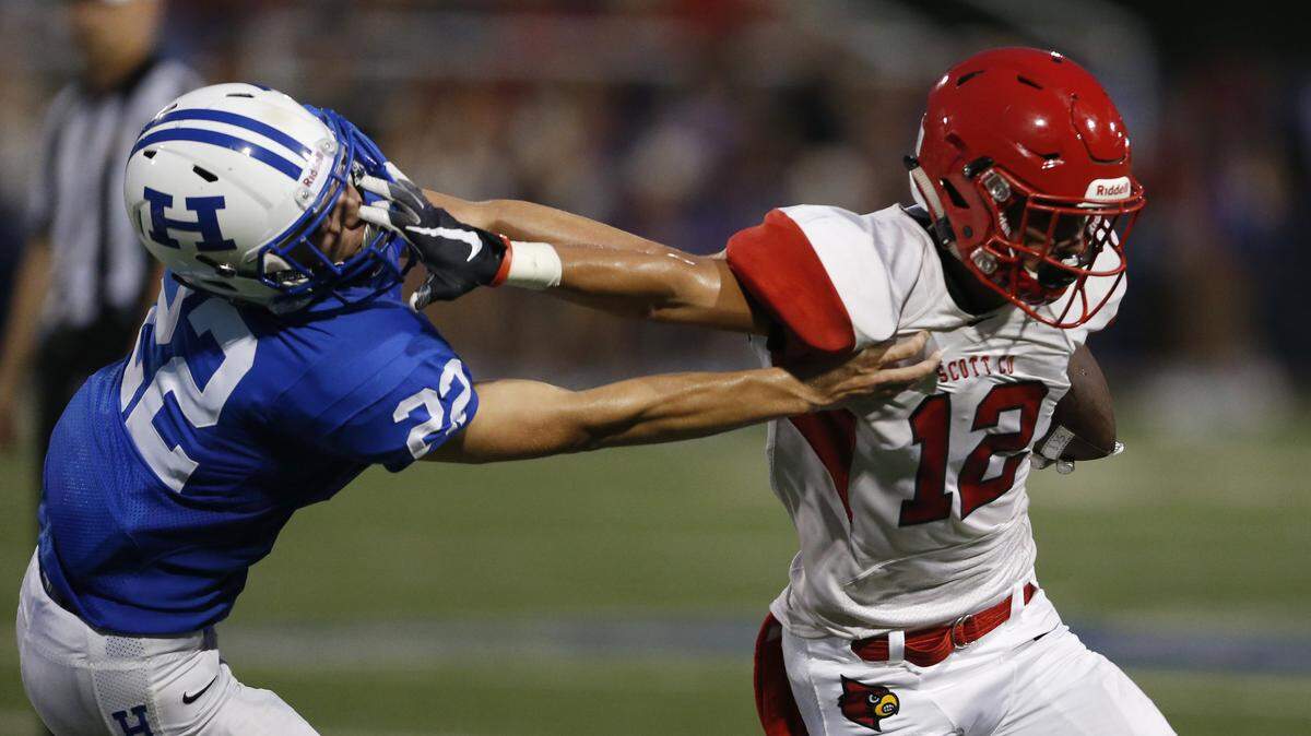 Scott County’s Payton Brown, 12, right, stiff arms Highlands’ Shabaz Butt, 22, during the second quarter of a football game held at Highlands High School in Fort Thomas, Kentucky Friday, Aug. 31, 2018.