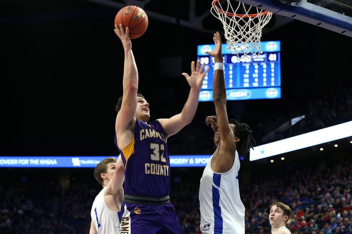 Campbell County’s Tanner Lawrence put up a shot over Walton-Verona’s Dieonte Miles on Friday. Lawrence scored 12 points and helped limit the 6-foot-10 Miles to 10.