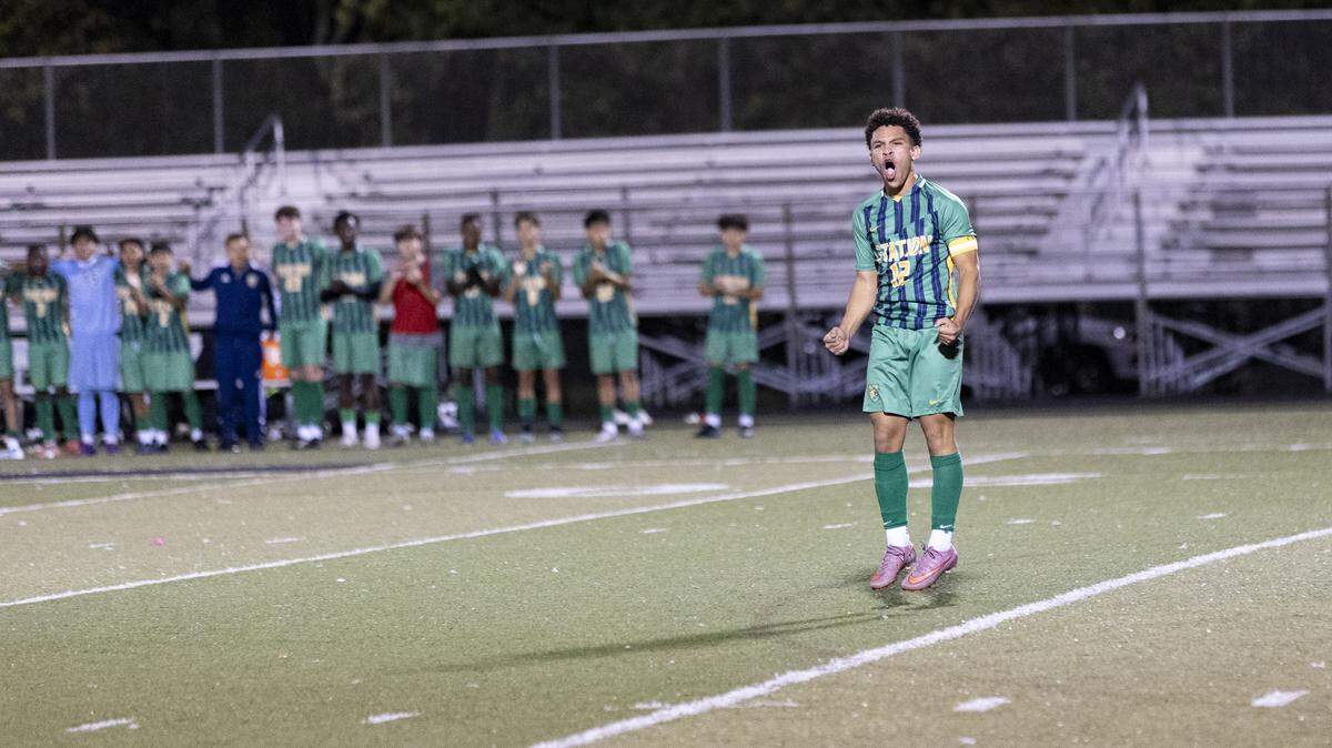Bryan Station’s Joaquin Guerrant egged on the Defenders’ fans after he made his penalty kick during the 11th Region boys soccer tournament championship game at Paul Laurence Dunbar High School on Friday.