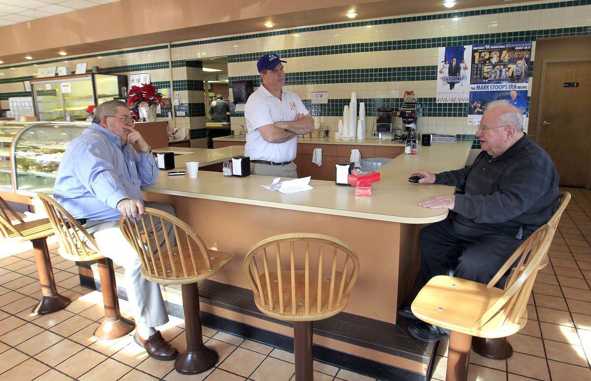 In 2013, the Rev. Wayne Smith, right, talked with David Griffin, left, and owner Fred Wohlstein at Donut Days on Southland Drive. Smith established Southland Christian Church and set it on a course to be one of Kentucky’s biggest churches.