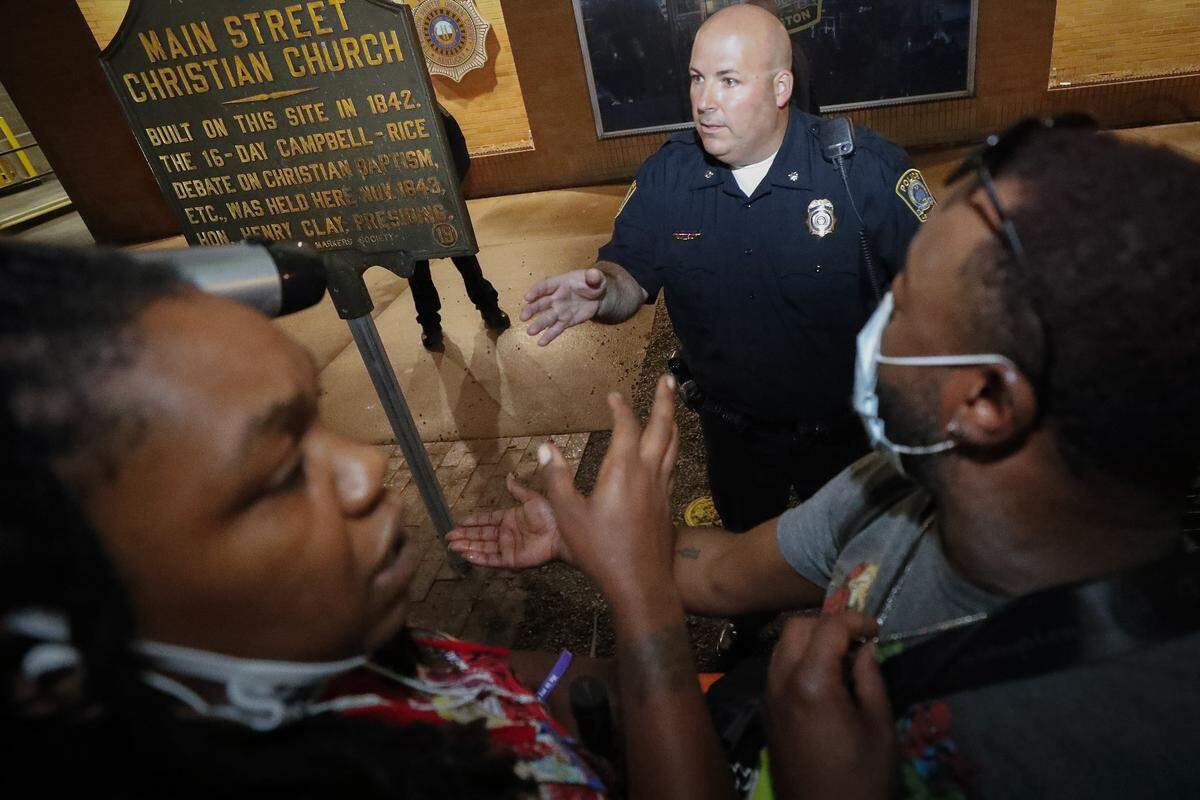 Lexington Police Asst. Chief Brian Maynard speaks with demonstrators outside of the police station along East Main Street during the seventh night of protests in downtown Lexington, Ky., Thursday, June 4, 2020. The protests come amid a nationwide outcry over the deaths of George Floyd in Minneapolis and Breonna Taylor in Louisville.