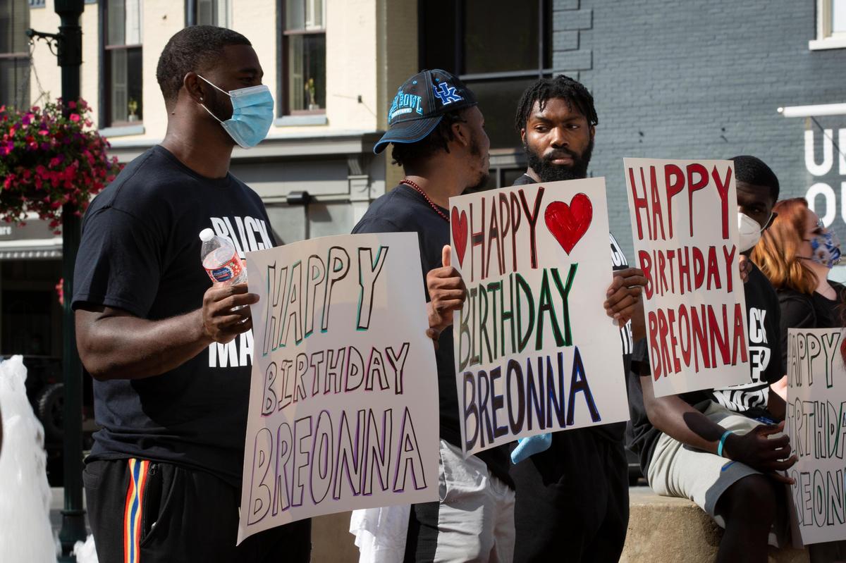Members of the Kentucky football team hold signs in solidarity during the car caravan protest held in honor of Breonna Taylor in Lexington, Ky., on Friday, June 5, 2020.