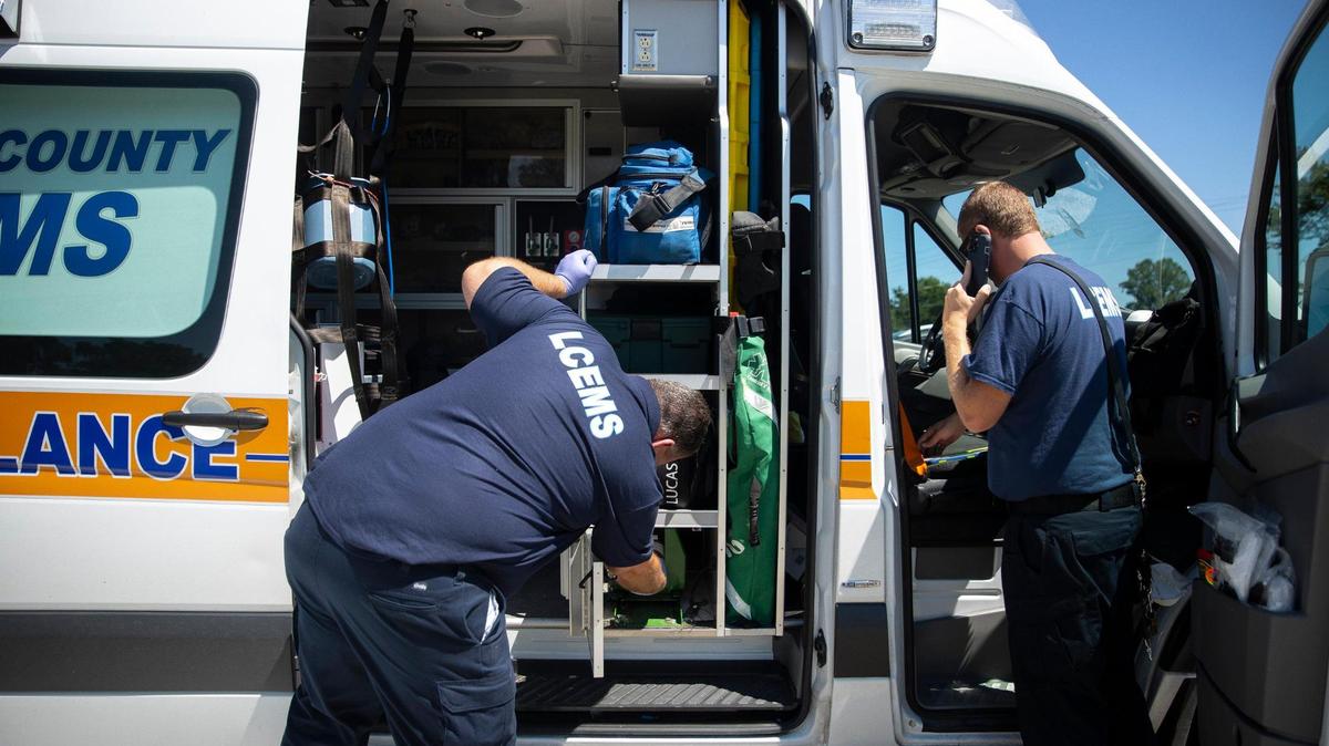 Dwayne Oliver, left, an EMT, and Doug Byers, a paramedic, prepare an ambulance for the next run after responding to a call in Beattyville, Ky., on Tuesday, Sept. 7, 2021.