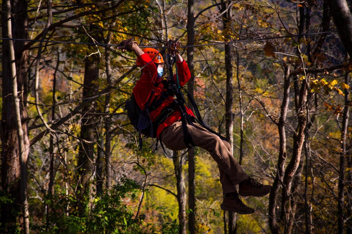 Adam Downs, manager and guide at Boone Creek Outdoors, rides a zip on Saturday, Oct. 17, 2020, in Lexington, Ky.